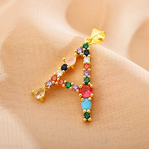 Macro detail of gold letter A pendant featuring vibrant multi-colored zircon stones