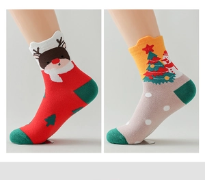 Detail of Christmas crew socks with reindeer and tree patterns in red and beige knit