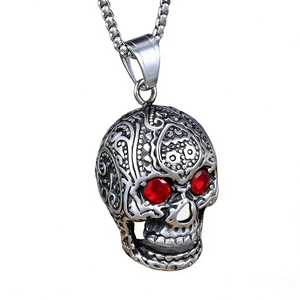 Gothic skull pendant necklace with red gemstone eyes and vintage steel engraving
