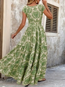 Outdoor back view of elegant green floral maxi dress with short sleeves and tiered skirt