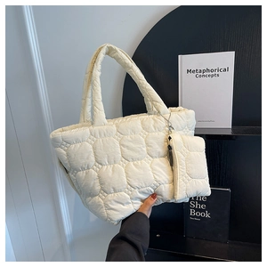Detail of quilted tote bag in cream white with a matching round coin purse attachment