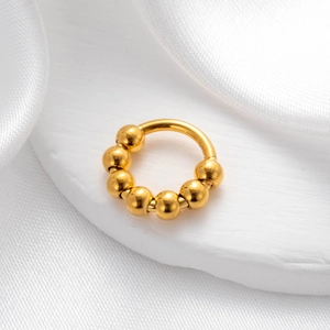 Polished gold stainless steel seamless hoop earring with beads on a stone platform