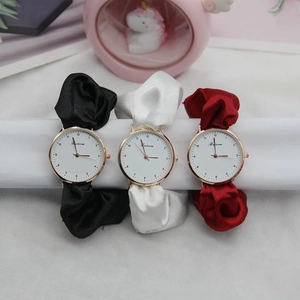 Elegant ribbon strap ladies watches in black, white and red with gold cases