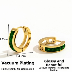 Close-up of gold stainless steel hoop earrings with green square-cut crystals