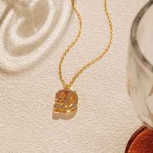Detailed view of an 18K gold plated D-letter pendant necklace with sparkling crystals