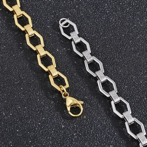 Detailed macro view of gold and silver stainless steel hexagonal link chains with lobster clasps