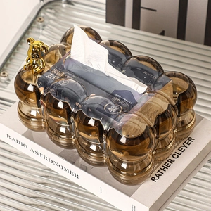 Detail of a brown bubble-textured tissue box featuring a golden bear on the lid