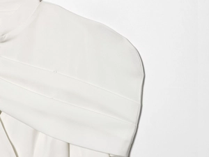Close-up of high-quality white textile texture and precision stitching on blazer