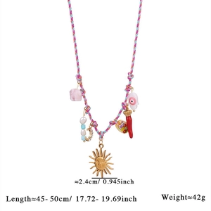 Detail view of Bohemian woven necklace featuring sun, evil eye, and crystal charms
