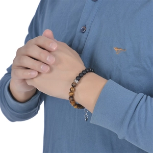 Men's 8mm Tiger Eye and matte black beaded bracelet with silver charm on male model