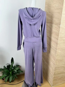 Back view of a purple hooded tracksuit with finger cuffs and drawstring wide-leg pants
