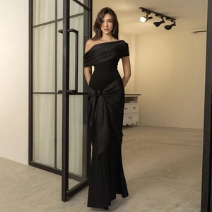 Elegant black off-shoulder mermaid evening gown with silk sheen and large waist bow detail