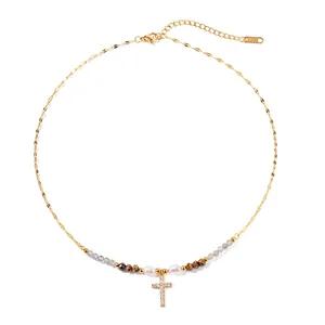 Gold titanium cross necklace with freshwater pearl and zircon pendant on a gold chain