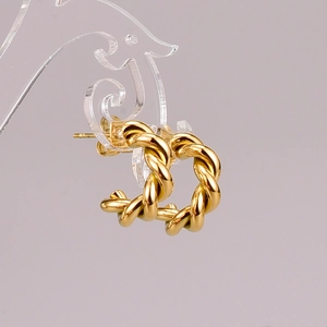 Detailed macro view of 18k gold plated twist hoop earrings with spiral rope texture