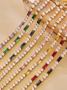 Detail showing multi-colored rectangular and round zircons set in a gold steel chain
