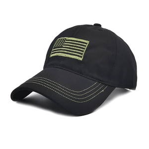 Detail of black tactical baseball cap featuring green US flag embroidery and stitched brim
