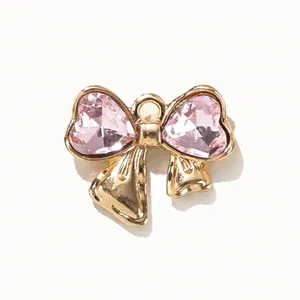 Golden alloy bow pendant with pink heart-shaped crystal for DIY necklace and bracelet