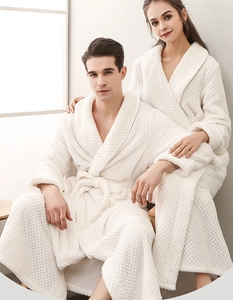Detail of white flannel bathrobe showing thick waffle texture and elegant shawl collar