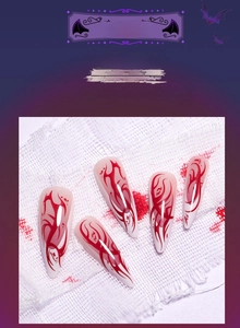 Detailed close-up of long stiletto Halloween press-on nails with red flame textures