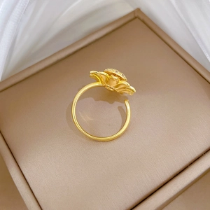 Macro detail of adjustable gold sunflower ring with shimmering micro-paved zircons