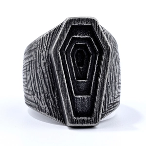 Macro detail of gothic punk coffin ring with vintage wood grain texture and dark finish