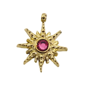 Detail of 14k gold star pendant featuring a pink zircon and textured metal finish