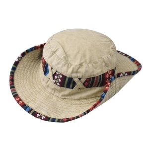 Close-up of beige cotton sun hat with bohemian style colorful woven decorative band