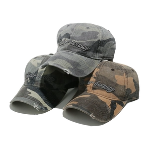 Detailed macro view of vintage camouflage baseball caps with 3D letter embroidery