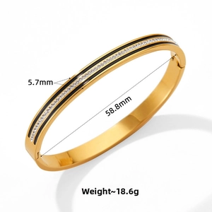 Detail shot of gold-plated bangle showing 5.7mm width and 18.6g weight metrics