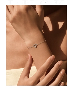 Close-up of heart-shaped pendant necklace with cubic zirconia on female model neck