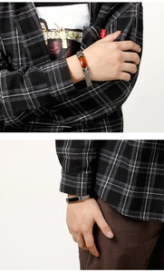 Detail of men's braided titanium steel bracelets in amber brown and obsidian black