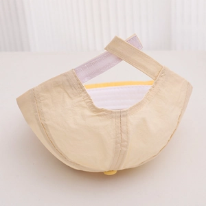 Detail view of the beige kids baseball cap showing the adjustable velcro strap at the back