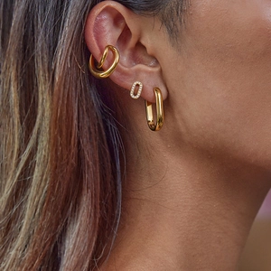 Elegant gold-plated stainless steel hoop earrings and stud set worn by a model
