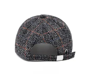Detail view of plaid baseball cap rear featuring adjustable silver buckle and tweed fabric