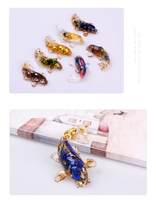 Detailed view of colorful resin koi fish ornaments with gold foil flakes and crystal stones