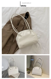 Macro detail of a white leather tote bag showing textured finish and sleek shoulder strap