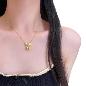 Elegant gold bow and lily of the valley bell pendant necklace for women in stainless steel