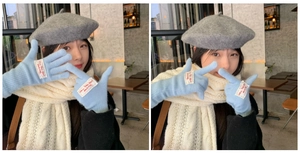 Detail of light blue knit gloves with stylish letter patch and wool winter accessories