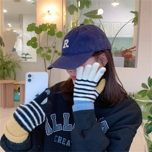 Close-up of knit striped gloves with touchscreen finger tips for mobile phone use
