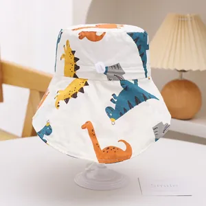 Close-up of kids sun hat featuring colorful cartoon dinosaur prints and adjustable drawstring