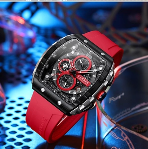 Close-up of a black brushed chronograph watch featuring a vibrant red silicone strap
