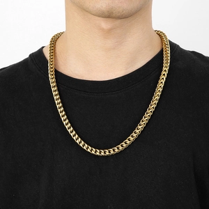 Hip-hop gold stainless steel cuban chain necklace worn by a male model on black shirt