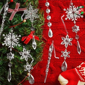 Close-up of sparkling crystal snowflakes and icicle ornaments on a Christmas tree branch