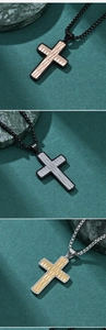 Detailed view of multi-color stainless steel cross pendants with unique blade texture