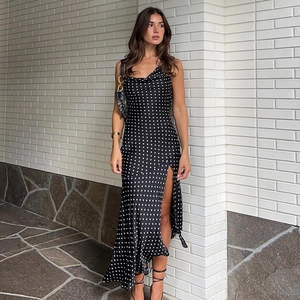 Side view of black polka dot slip dress with high slit and elegant cowl neck design