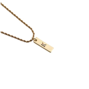 Detailed shot of golden twisted chain necklace with colorful zircon rectangular pendant