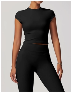 Close-up of seamless black cropped yoga top with breathable fabric and round neckline
