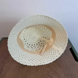 Detail of crochet sun hat interior with beige woven texture and sweatband