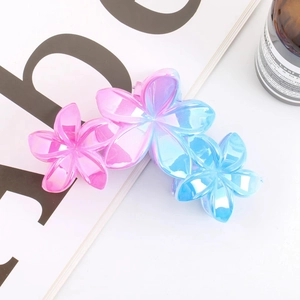 Detail of flower hair claw clip with pink and blue gradient and iridescent pearl finish