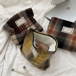 Flat lay of vintage plaid makeup bags with metal zipper and premium fabric lining